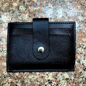 black wallet for cash, cards and coins